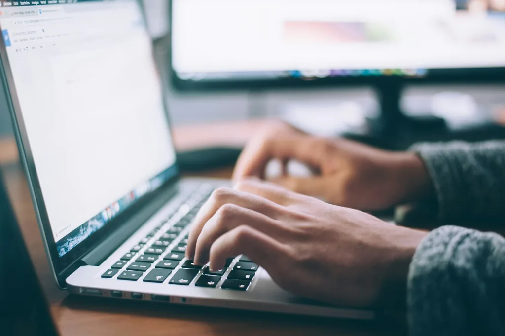 Open laptop on a desk — the channel where most real estate email sequencing happens