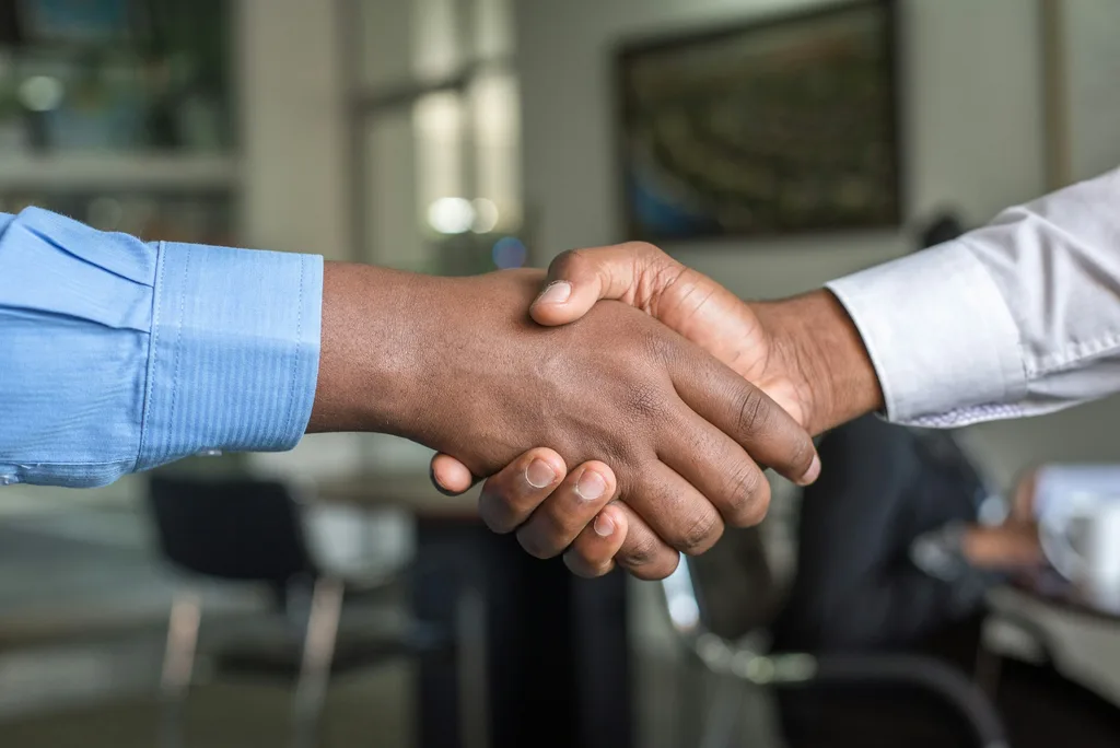 Two people reviewing paperwork together — the operational backbone of real estate transaction coordination