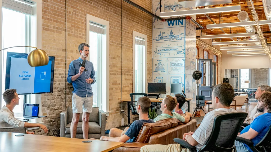 Real estate agent walking sellers through a listing presentation at the kitchen table